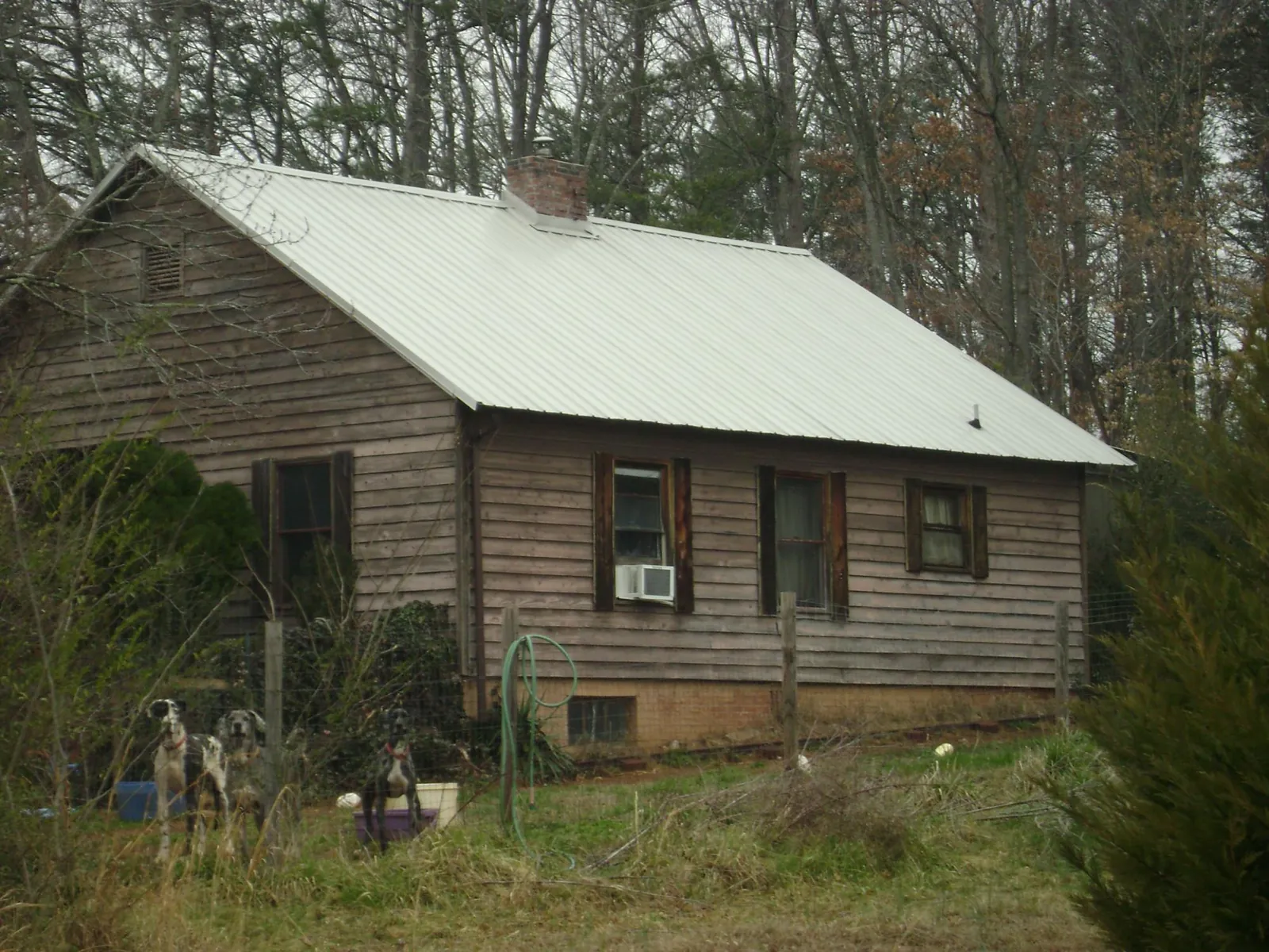 White metal roof on an old wood sided farmhouse, from a Metal Roof Installation job in East Kingston